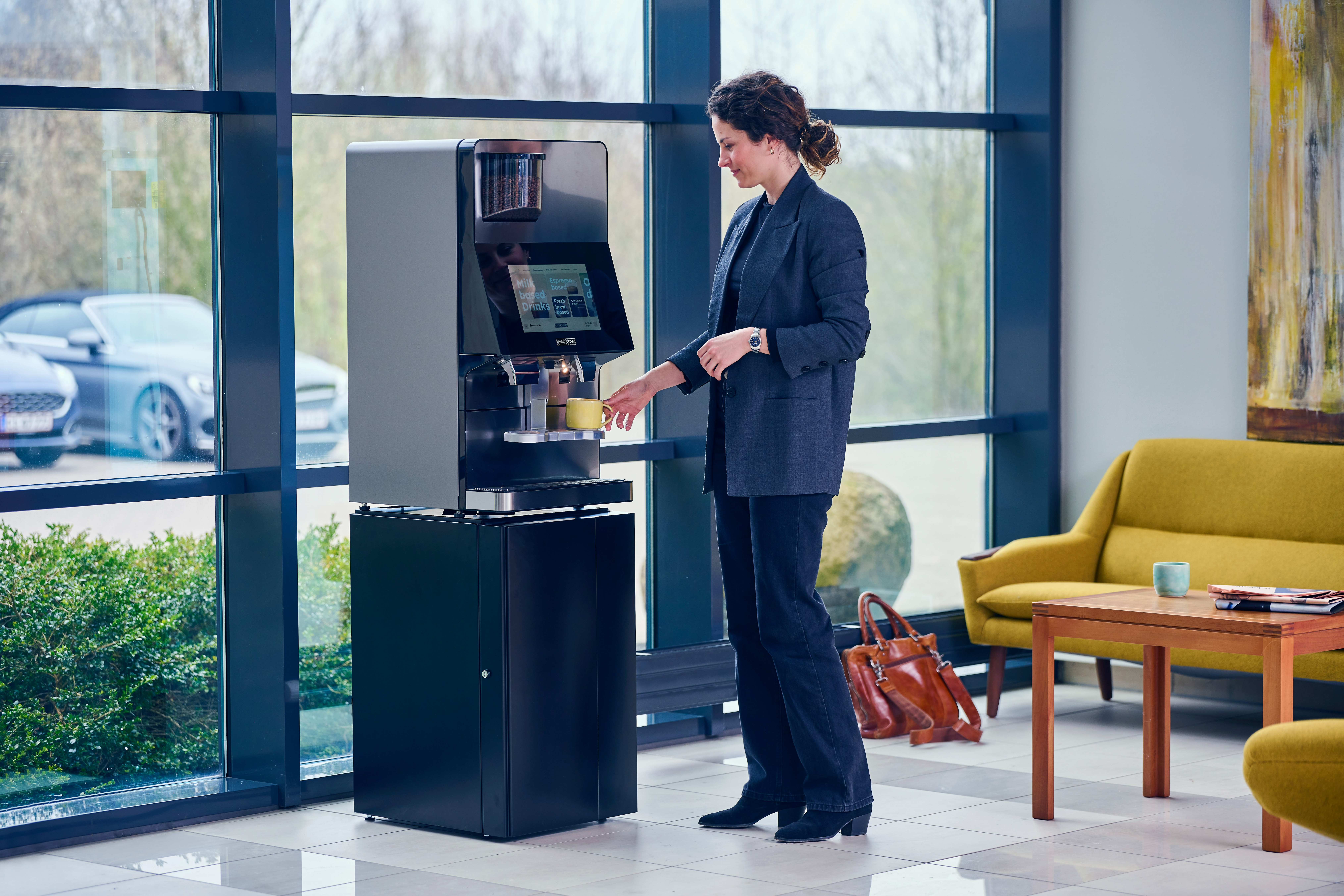 Woman taking coffee from w100 coffee machine