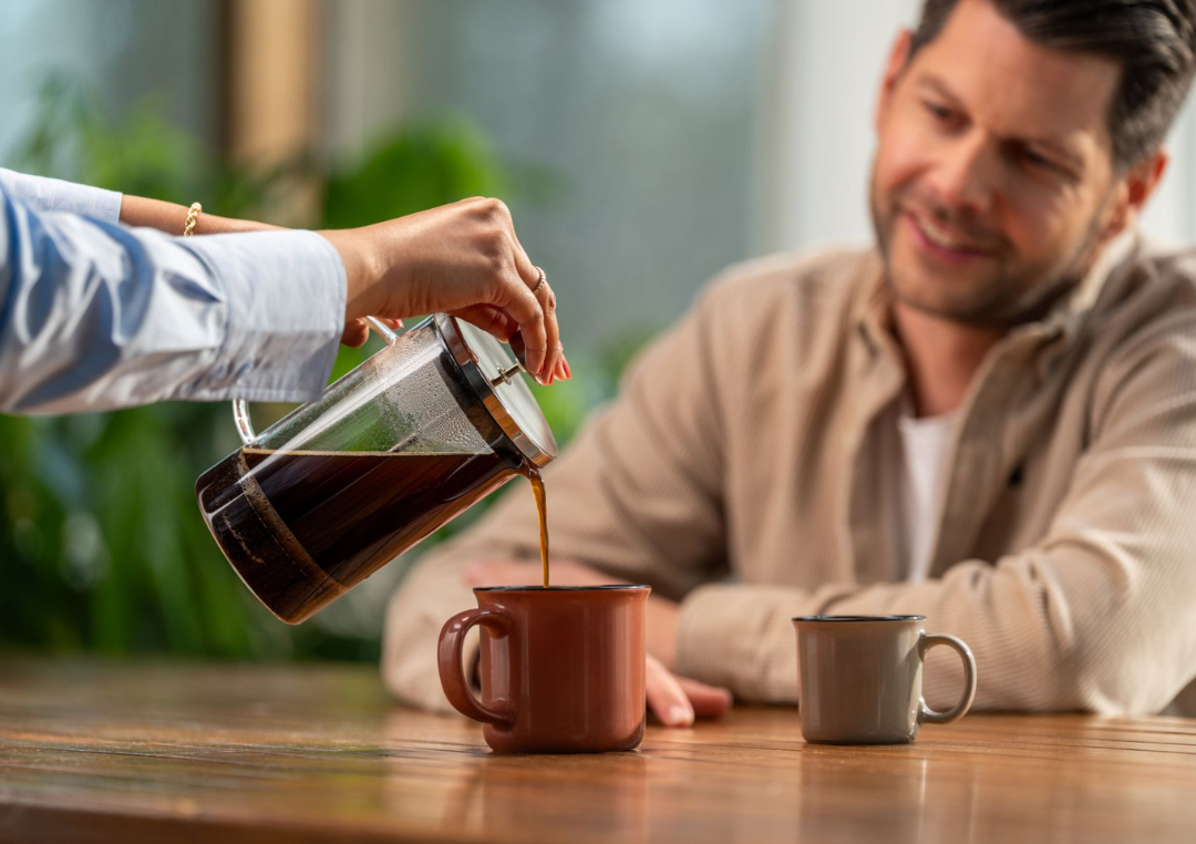 Person serving Friele Coffee to man